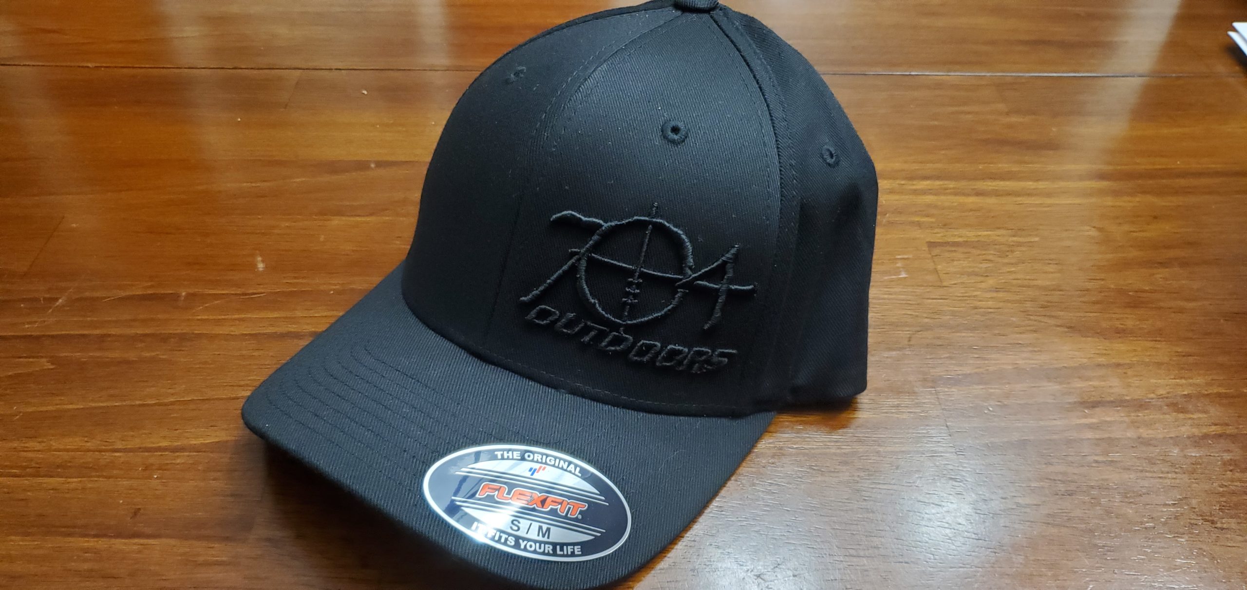 704 Outdoors Hat – Flexfit Raised Black Embroidery on Black Hat